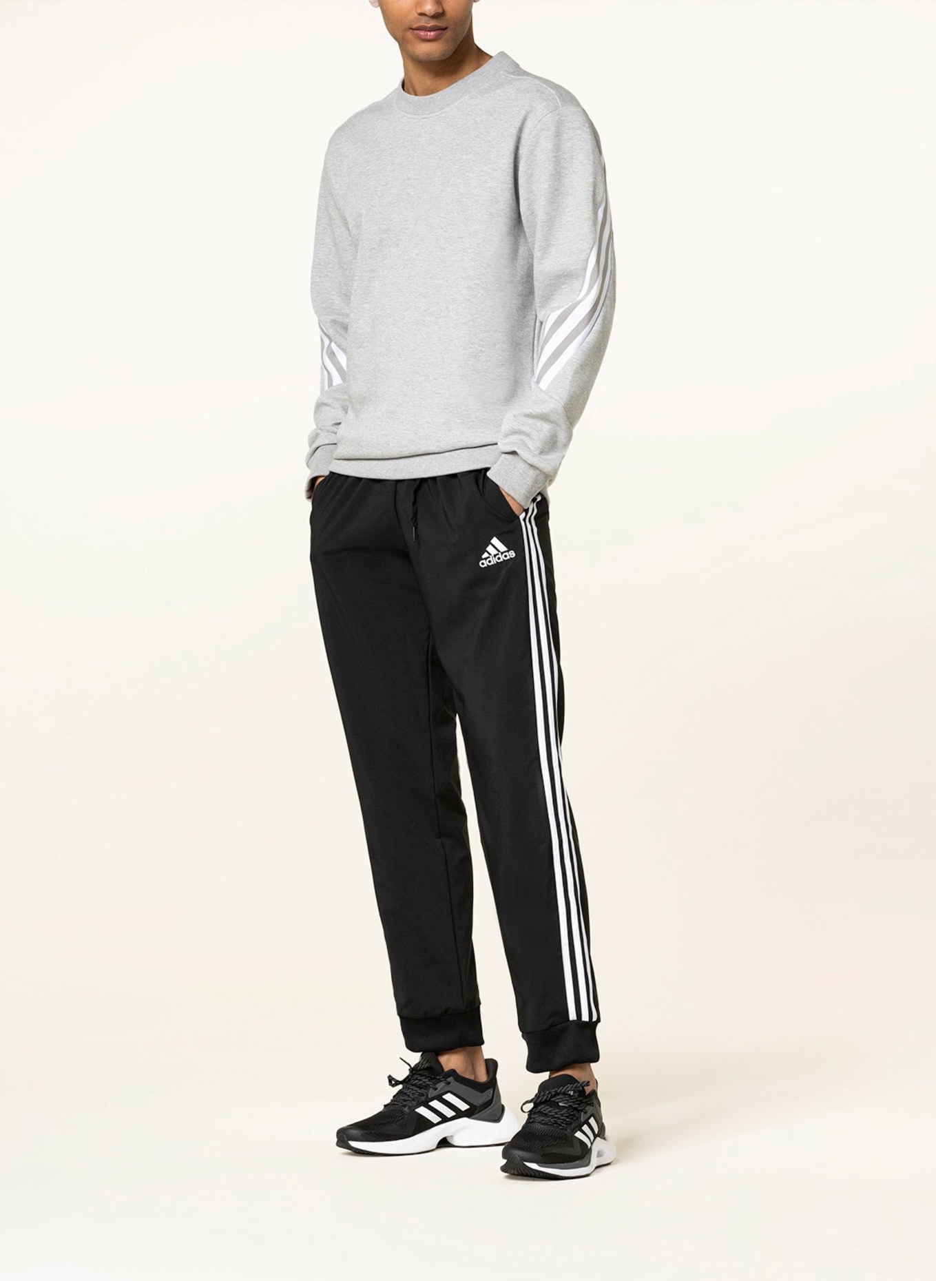 Collection of four insulated travel bottles on wooden shelf.