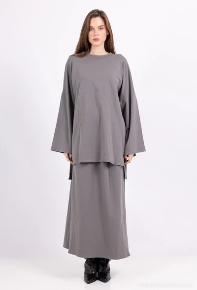 Collection of four insulated travel bottles on wooden shelf.