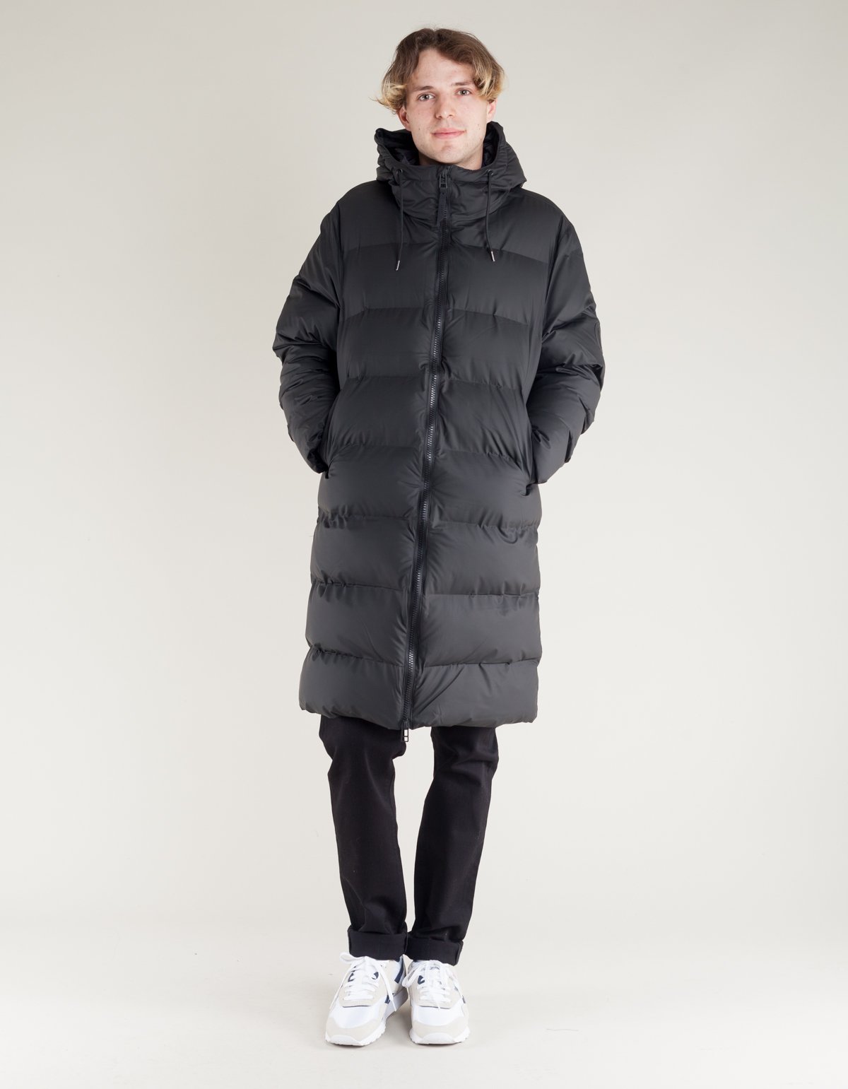 Collection of four insulated travel bottles on wooden shelf.